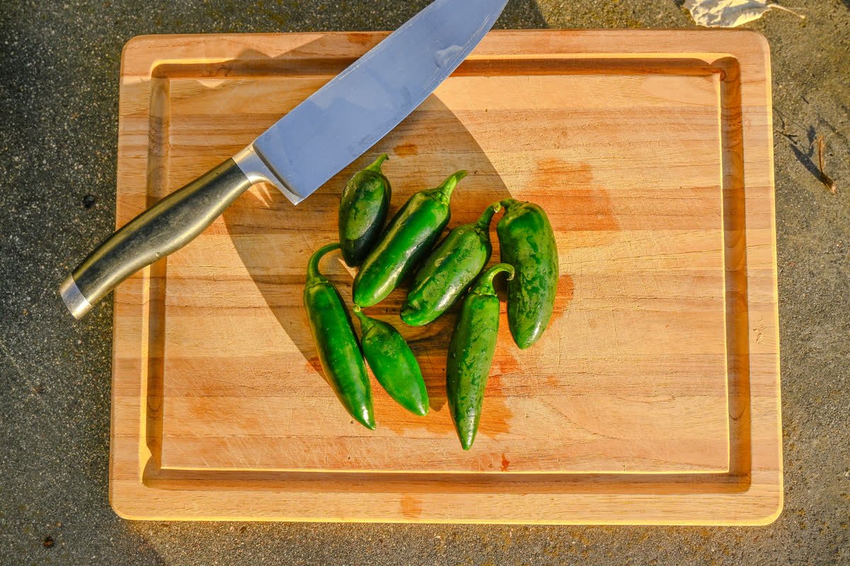 Jalape&ntilde;os on a cutting board beside a knife